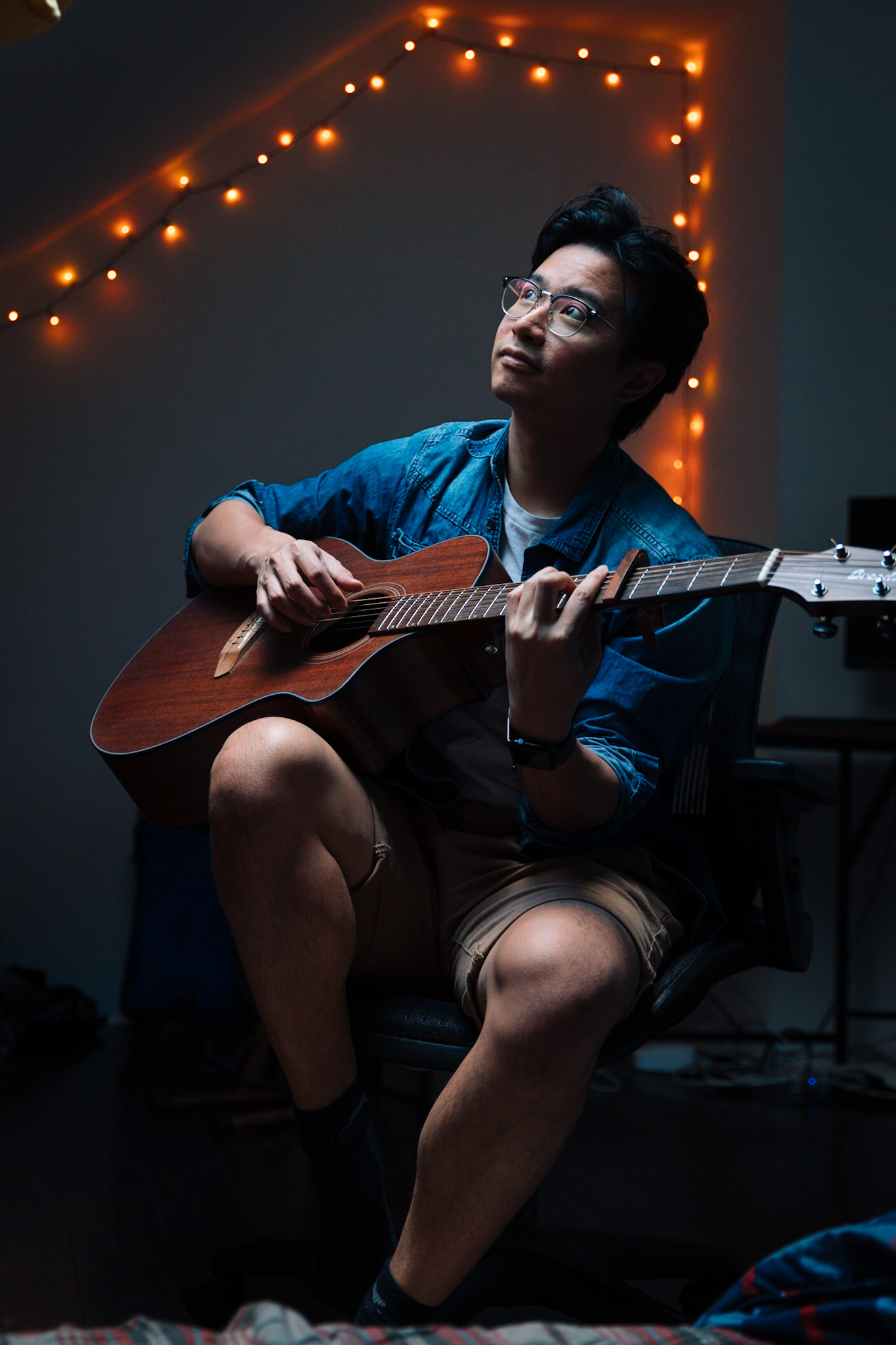 Indoor portrait with guitar and string lights